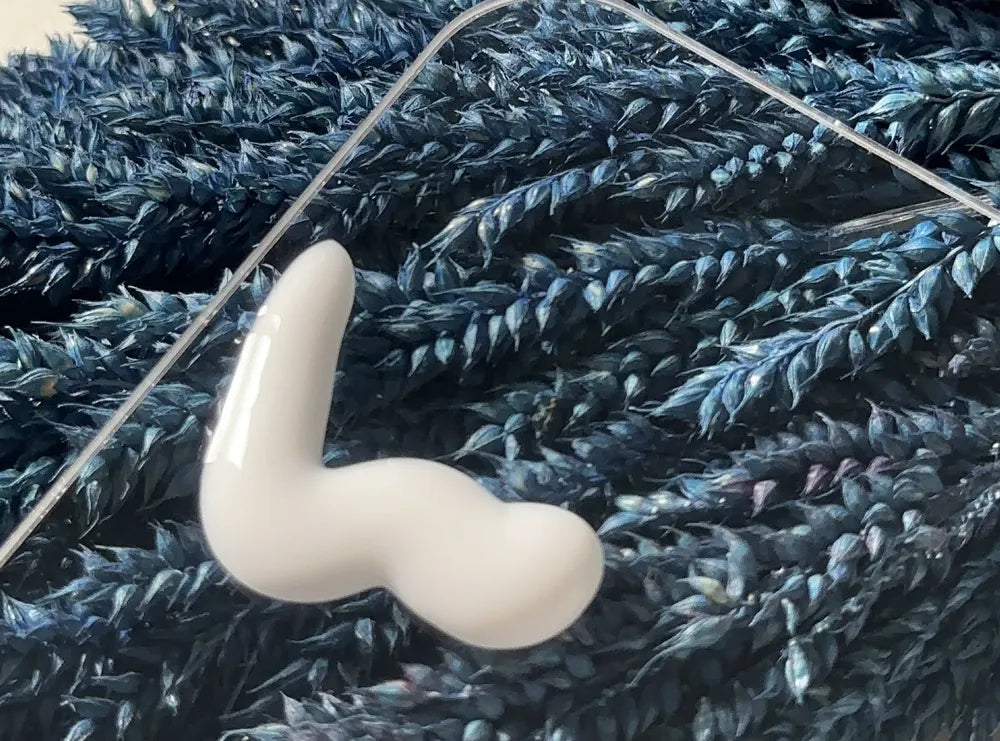 A swirl of Neutralyze moisturizer on navy lavender